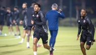 Qatar's Homam Al Amin (centre) trains with teammates. 