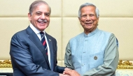 In this handout photo released by Pakistan's Press Information Department (PID), Pakistan's Prime Minister Shehbaz Sharif (left) shakes hands with Bangladesh's interim leader Muhammad Yunus during a bilateral meeting on the sidelines of the D-8 summit in Cairo on December 19, 2024. (Photo by Pakistan's Press Information Department (PID) / AFP) 