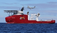 This handout photo taken and released on April 9, 2014 by the Australian Defence shows a Royal Australian Air Force AP-3C Orion flying past Australian Defence Vessel Ocean Shield on a mission to drop sonar buoys to assist in the acoustic search for the missing Malaysia Airlines flight MH370 in the southern Indian Ocean. Photo by LSIS BRADLEY DARVILL / AUSTRALIAN DEFENCE / AFP