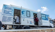 Doctors examine patients aboard a truck used as a mobile clinic set up by Stavros Niarchos mobile medical unit on Sikinos Island, on December 14, 2024. Photo by Spyros BAKALIS / AFP