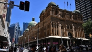 Shoppers are seen in the central business district in the run up to Christmas and New Year's Eve in Sydney on December 20, 2024. (Photo by Saeed KHAN / AFP)