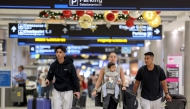 Travelers pass through the Miami International Airport as some of the year's busiest travel days occur during the holiday season on December 20, 2024 in Miami, Florida. (Photo by Joe Raedle/Getty Images/AFP)