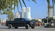 This photograph taken on November 12, 2024 shows car enthusiast Zohaib Khan driving a Toyota Tundra pick-up truck locally known as 'Dala', along a street in Karachi. (Photo by Asif Hassan / AFP) 