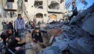 People search for survivors at the site of an Israeli strike that targeted the Abu Samra family home in Deir el-Balah in the central Gaza Strip on December 22, 2024. (Photo by Eyad Baba / AFP)