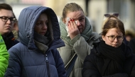 People mourn at a makeshift memorial outside the Johanniskirche (Johannes Church), near the site of a car-ramming attack on a Christmas market in Magdeburg, eastern Germany, on December 22, 2024. Photo by John MACDOUGALL / AFP.