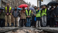 Students, pupils and citizens block a street in front of the Faculty of Law in Belgrade on December 20, 2024, standing in silence to honour the 15 victims of the tragedy that occurred at the railway station in Novi Sad in November 2024. Photo by Andrej ISAKOVIC / AFP