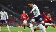 Manchester United's Moroccan defender #03 Noussair Mazraoui (right) fouls Bournemouth's Dutch striker #19 Justin Kluivert (centre) for a penalty during the English Premier League football match between Manchester United and Bournemouth at Old Trafford in Manchester, north west England, on December 22, 2024. (Photo by Darren Staples / AFP)