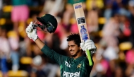 Pakistan's Saim Ayub celebrates after scoring a century (100 runs) during the third one day international (ODI) cricket match batween South Africa and Pakistan at The Wanderers Stadium in Johannesburg on December 22, 2024. (Photo by Phill Magakoe / AFP)