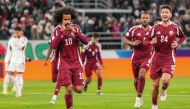 Qatar's Akram Afif (left) celebrates with teammates after scoring a goal against UAE.