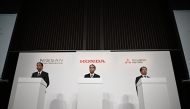 (L to R) Makoto Uchida, President and CEO of Nissan motor corporation, Toshihiro Mibe, President and Representative Executive Officer of Honda, and Takao Kato, President and CEO of Mitsubishi Motors attend a joint press conference in Tokyo on December 23, 2024. Photo by Philip FONG / AFP.
