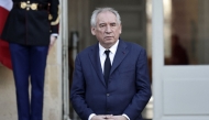 France's Prime Minister Francois Bayrou stands at attention as he observes a minute of silence as part of an official day of mourning for the victims of Cyclone Chido at The Hotel Matignon in Paris on December 23, 2024. (Photo by Stephane De Sakutin / AFP)