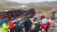 This handout picture released by the Iranian Red Crescent shows rescue workers and police officers at the scene of a fatal bus accident in the Pa-alam area on December 21, 2024. Photo by Iranian Red Crescent / AFP