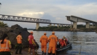 This handout photo released by Tocantins Fire Department shows firefighters during a rescue operation after the Juscelino Kubitschek de Oliveira bridge connecting Tocantins and Maranhao fell on December 22, 2024 over the Tocantins river at the city of Aguiarnopolis, Tocantins state, Brazil. (Photo by Cynthia LIUTKUS-PIERCE / AFP)