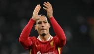 Liverpool's Dutch defender #04 Virgil van Dijk applauds fans on the pitch after the English Premier League football match between Tottenham Hotspur and Liverpool at the Tottenham Hotspur Stadium in London, on December 22, 2024. Photo by Glyn KIRK / AFP