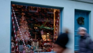 Pedestrians pass Christmas items displayed in the window of 43 Camden Passage, owned by Bob Borzello, in London on December 20, 2024. Photo by BENJAMIN CREMEL / AFP