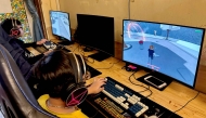 Youths play video games in a gaming room in Hanoi on December 25, 2024. (Photo by Nhac Nguyen / AFP)
 