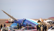 Emergency specialists work at the crash site of an Azerbaijan Airlines passenger jet near the western Kazakh city of Aktau on December 25, 2024. (Photo by Issa Tazhenbayev / AFP)
 