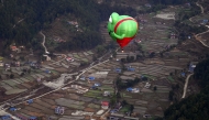 Hot air balloons rise in the sky during the International Hot-Air Balloon festival in Pokhara on December 24, 2024. (Photo by PRAKASH MATHEMA / AFP)
 