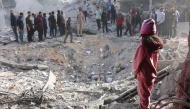 Civilians check the site of an Israeli strike in a residential area in the Tuffah neighbourhood, east of Gaza City, on December 26, 2024. Photo by Omar AL-QATTAA / AFP