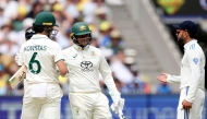 Australia's Sam Konstas (L) chats with India's Virat Kohli (R) on day one of the fourth cricket Test match between Australia and India at the Melbourne Cricket Ground (MCG) in Melbourne on December 26, 2024. (Photo by Martin KEEP / AFP) 