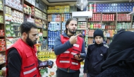 QRCS volunteers talking to a beneficiary.