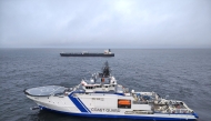 This handout picture released by The Finnish Border Guard on December 26, 2024 shows a Finnish Border Guard's ship Turva (front) and the oil tanker Eagle S on the sea near Porkkalanniemi. Photo by Handout / Finnish Border Guard / AFP