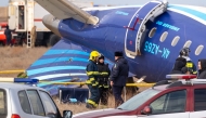 Emergency specialists work at the crash site of an Azerbaijan Airlines passenger jet near the western Kazakh city of Aktau on December 25, 2024. Photo by Issa Tazhenbayev / AFP