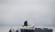 A photo taken on December 28, 2024 off Porkkalanniemi, Kirkkonummi, in the Gulf of Finland, shows oil tanker Eagle S (R), which flies under the flag of the Cook Islands, next to Finnish border guard ship Uisko (back C) and tugboat Ukko (front L). (Photo by Jussi Nukari / Lehtikuva / AFP)