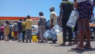 Motorists join long queues at a gas station in Maputo on December 27, 2024. (Photo by Amilton Neves / AFP)
