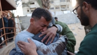 A Palestinian man mourns a relative, killed in an Israeli strike, at the Nasser Hospital in Khan Yunis in the southern Gaza Strip on December 28, 2024. (Photo by BASHAR TALEB / AFP)
 