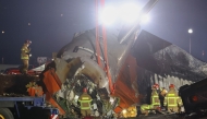 Firefighters and rescue personnel work near the scene where a Jeju Air Boeing 737-800 series aircraft crashed and burst into flames at Muan International Airport in South Jeolla Province, some 288 kilometers southwest of Seoul on December 29, 2024. (Photo by YONHAP / AFP) 