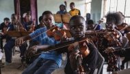 Steve Otieno rehearses with the Ghetto Classics orchestra. (Photo by Malin Fezehai for The Washington Post)