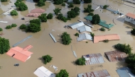 This aerial view shows houses submerged under water in Maiduguri in north-eastern Nigeria on September 10, 2024. (Photo by Audu Marte / AFP)

