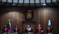 The second vice president of Venezuela's Supreme Court of Justice (TSJ), Tania D'Amelio (C), speaks about a fine imposed on the social network TikTok at the TSJ building in Caracas on December 30, 2024. (Photo by Federico Parra / AFP)