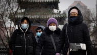 File: People wear face masks as they walk on a snowy morning as the coronavirus disease (COVID-19) continues in Beijing, China, on January 20, 2022. (Reuters)

