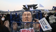 An effigy of South Korea's impeached President Yoon Suk Yeol is seen in a mock prison as protesters take part in a rally calling for Yoon's ouster in front of the Gwanghwamun Gate of Gyeongbokgung Palace in Seoul on December 21, 2024. Photo by Jung Yeon-je / AFP.