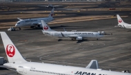 Japan Airlines passenger planes are seen on the tarmac at Haneda Airport in Tokyo on December 26, 2024. Photo by Yuichi YAMAZAKI / AFP.