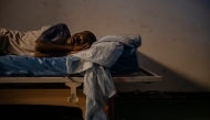 A young man rests on the bed of his room at the psychiatry centre of the CHS hospital in Nouakchott, December 12, 2024. Photo by MICHELE CATTANI / AFP.