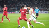 Saudi Arabia's Salem Al Dawsari (right) and Oman's Jameel Al Yahmadi vie for the ball possession.