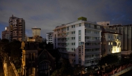 Residential buildings and a hotel are seen in the dark in San Juan, Puerto Rico after a major power outage hit the island on December 31, 2024. (Photo by Ricardo ARDUENGO / AFP)
