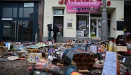 Burnt down fireworks are seen in front of a shop in Berlin's Weissensee district on January 1, 2025. (Photo by Tobias SCHWARZ / AFP)