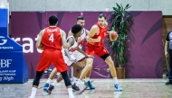 Al Arabi’s Elmedin Kikanovic  (right) is challenged by Al Rayyan players.