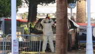 An investigator photographs a Tesla Cybertruck that exploded outside the lobby of President-elect Donald Trump's hotel on January 1, 2025, in Las Vegas. Photo by WADE VANDERVORT / AFP.