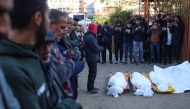 People recite a prayer over the bodies of displaced Palestinians killed in an overnight Israeli strike on a makeshift displacement camp in Mawasi Khan Yunis in the southern Gaza Strip, in the yard of the Nasser hospital on January 2, 2025. Photo by BASHAR TALEB / AFP