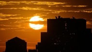 The sun rises behind high-rise buildings in Beijing on September 6, 2024. Photo by ADEK BERRY / AFP