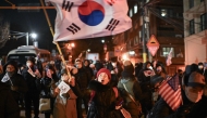 A woman waves South Korea's flag during a rally to support South Korea's impeached president Yoon Suk Yeol near the presidential residence in Seoul on January 2, 2025. Photo by Philip FONG / AFP