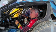 Ford M-Sport’s Spanish Driver Carlos Sainz sits inside his car after a practice session ahead of the Dakar Rally 2025, in Bisha.