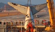 A crane lifts the tail section during the salvage operation of the Jeju Air Boeing 737-800 aircraft which crashed and burst into flames at Muan International Airport, in Muan on January 3, 2025. Photo by YONHAP / AFP