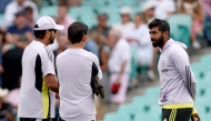 India's Rohit Sharma (L) and Jasprit Bumrah (R) talk with team coach Gautam Gambhir before the start of day one of the fifth Test match between Australia and India at The SCG in Sydney on January 3, 2025. (Photo by David Gray / AFP) 