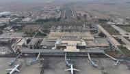 An aerial view shows passenger planes of Syria's private airline company Cham Wings on the tarmac of the closed international airport of Damascus on December 11, 2024. (Photo by Omar Haj Kadour / AFP)